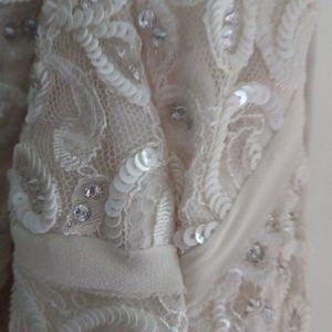 Off white silk wedding gown with beading. Size 16, uneven hem.